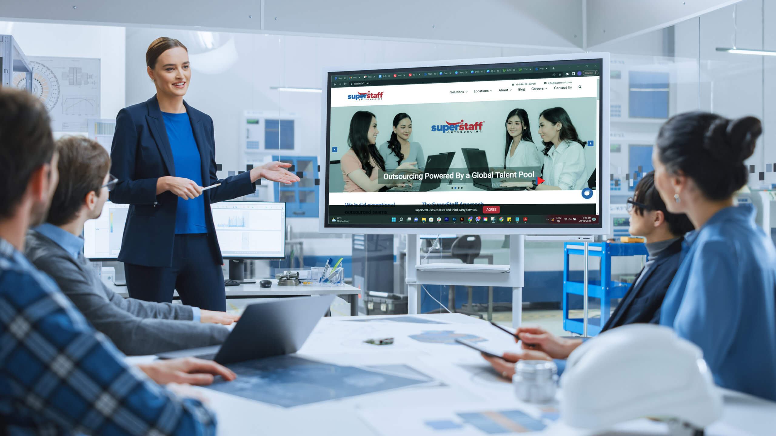 nearshoring strategy A business manager inside a board room is explaining a nearshoring strategy to fellow executives.