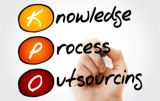 A hand holding a pen pointing to the words, knowledge process outsourcing