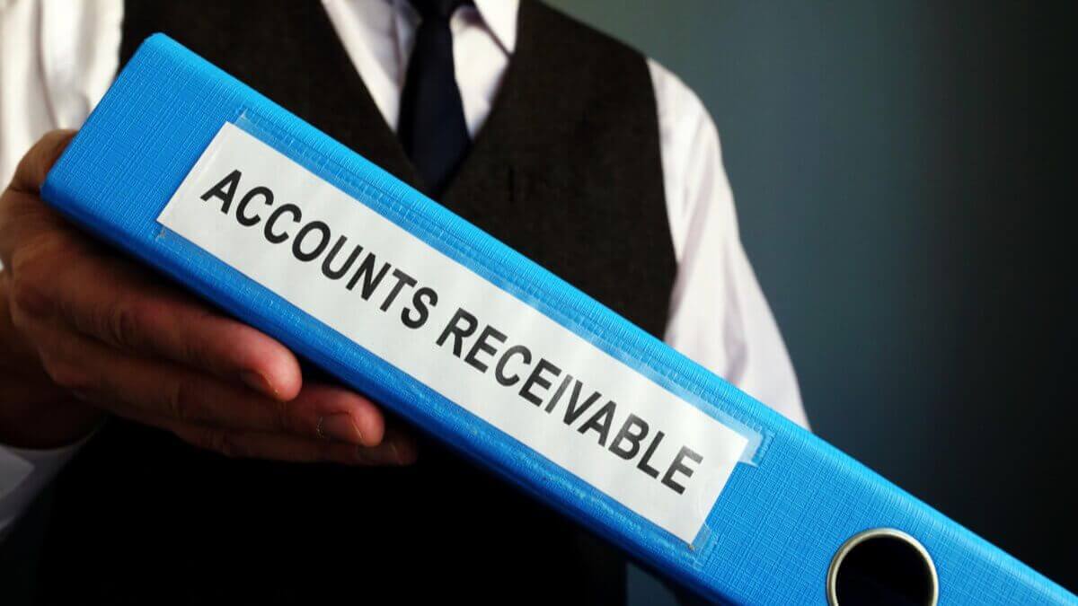 outsourcing-accounts-receivable-1200×675 A man holding a folder labeled accounts receivable