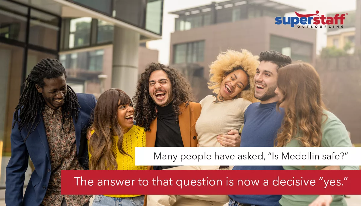 Is-Medellin-safe An image shows a group of people walking in a street in Medellin, Colombia.