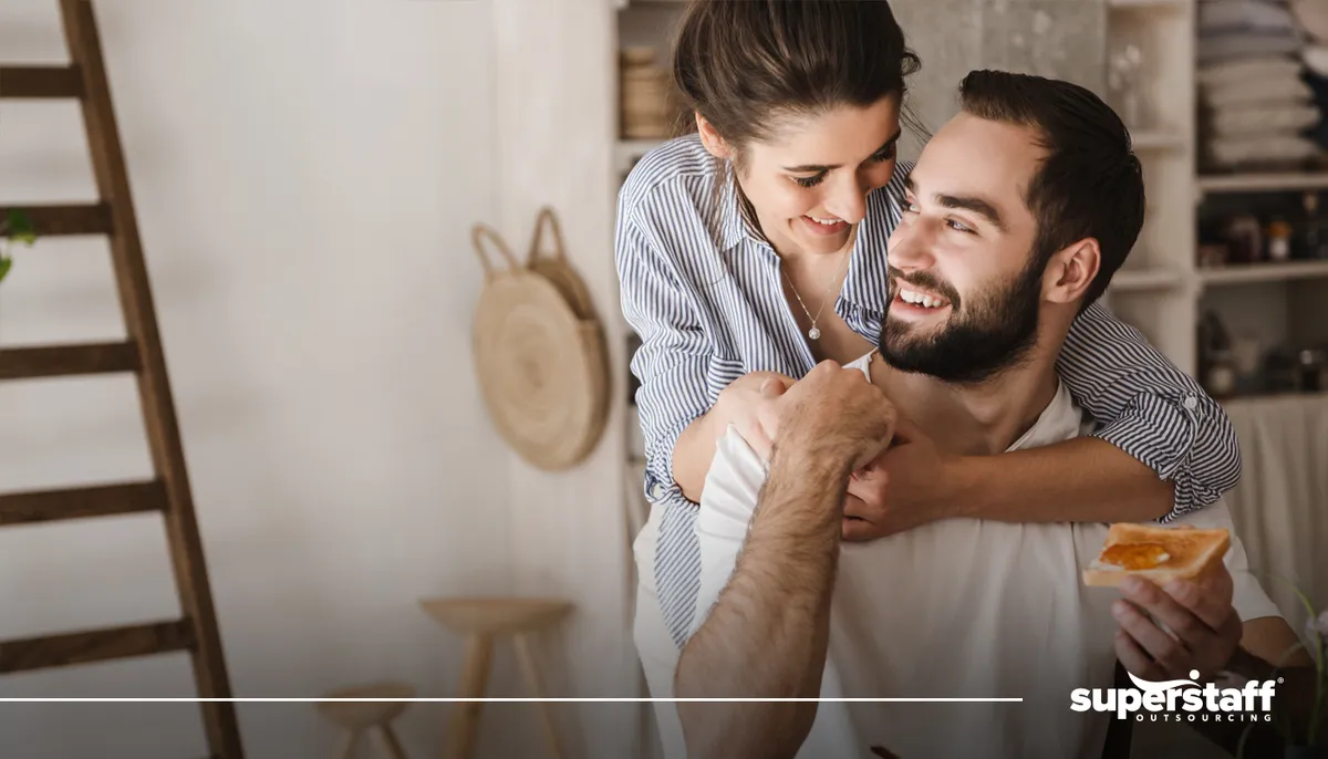 A photo shows a woman embracing a man from the back.