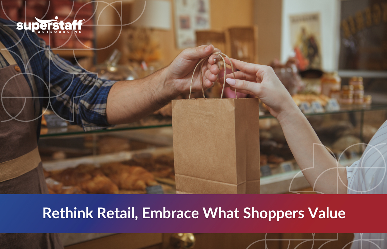Close-up of a store employee handing a paper bag to a customer in a bakery setting, illustrating personal service and shifting retail industry trends 2025 focused on consumer value.