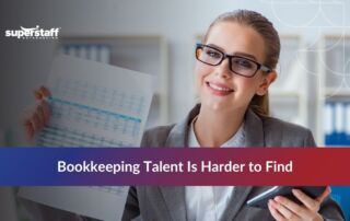 Professional woman holding financial documents, highlighting the challenge of finding bookkeeping talent in 2025.