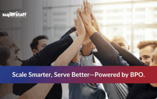 Group of diverse professionals celebrating teamwork with hands joined, emphasizing BPO advantages for business growth