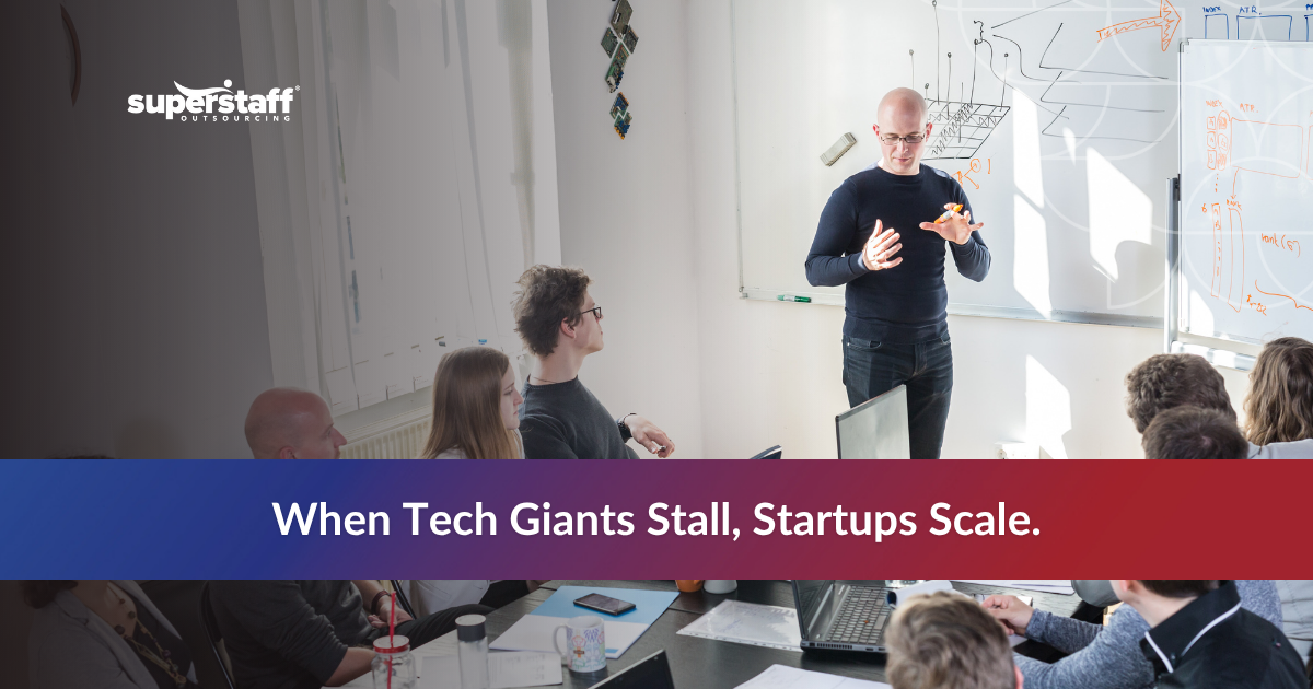 Startup team meeting with “Startups Scale” message