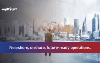 Business professional overlooks a modern city skyline, symbolizing nearshoring and onshoring trends in manufacturing.