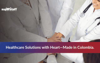 Healthcare workers putting hands together to represent teamwork in outsourced healthcare services.