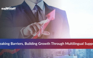 Man pointing at a rising arrow symbolizing business growth with multilingual outsourcing services.