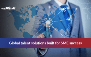 Business professionals shaking hands at a meeting table promoting offshore staffing services to boost SME growth and efficiency.