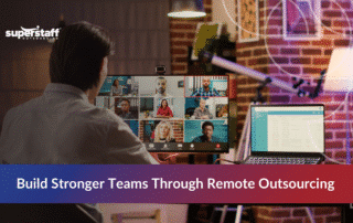 Professional participating in remote outsourcing video conference with diverse global team members on screen